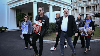 Orna and Ronen Neutra left, parents of Omer Neutra, with other families of Americans being held hostage by Hamas after meeting officials at the White House on November 12. AFP