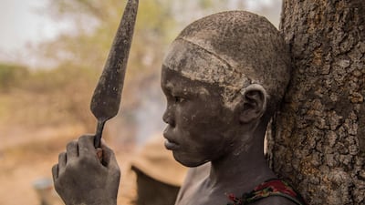 A Sudanese boy holds his spear.