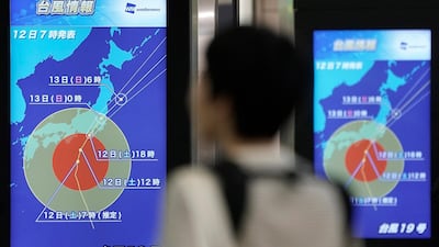 A railway passenger watches a display showing information about Typhoon Hagibis at Shinjuku railway station in Tokyo, Japan. EPA