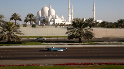 One of the solar-powered cars competing in the Abu Dhabi Solar Challenge passes by Sheikh Zayed Grand Mosque on Friday. Courtesy of Abu Dhabi Solar Challenge