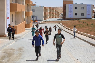 Children play during the inauguration of newly constructed homes for displaced people near the Syrian town of Qabasin, located northeast of the city of Al-Bab, some 30 kilometres from Aleppo. AFP
