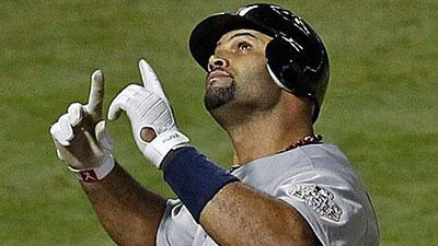 Albert Pujols celebrates after hitting his third home run of the night against Texas Rangers as St Louis Cardinals open a 2-1 lead in the World Series.