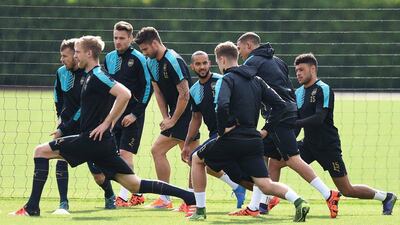 Arsenal players stretch during a team training session on Monday in London. Andy Rain / EPA