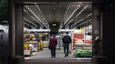 Customers enter the fruits and vegetables hall at the Rungis wholesale market. Etienne Laurent / EPA