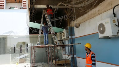 Workers tend to the damaged parts of Saudi Arabia's Abha airport. Reuters