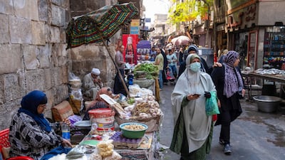 Shoppers in a market in Cairo in October. Lingering summer temperatures and a shortage of natural gas are increasing pressure on Egypt's energy network. Bloomberg.