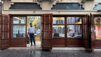 A shopkeeper in Dubai watches the rain. Antonie Robertson / The National
