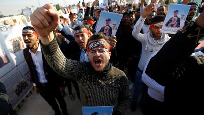 Iraqi students gather to mark the one year anniversary of the killing of senior Iranian military commander General Qassem Soleimani and Iraqi militia commander Abu Mahdi al-Muhandis in a U.S. attack, at the Wadi al-Salam cemetery, in Najaf, Iraq. Reuters