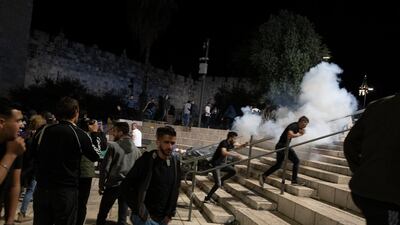 Palestinians react as Israeli police fire stun grenades at the Damascus Gate to the Old City of Jerusalem, following clashes at the Al Aqsa Mosque compound. AP Photo