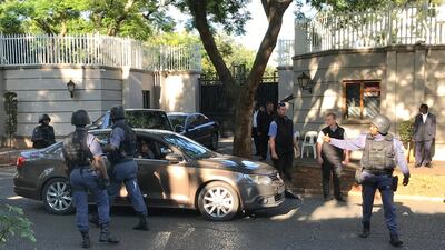 Members of the Hawks special police unit raid the compound of the Gupta family in Johannesburg, South Africa, on February 14, 2018. Kim Ludbrook / EPA