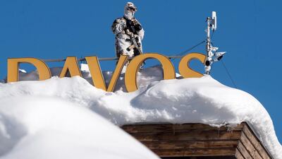 A member of the Swiss special police forces stands on the roof of the Kongress Hotel next to the Congress Center the first day of the World Economic Forum in Davos. EPA