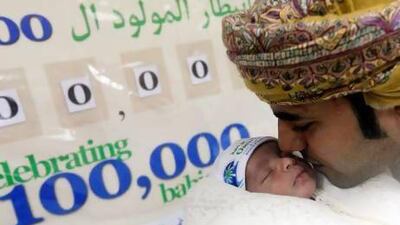 Ahmed Al Omeri with his newborn son Hassan Ahmed, who is the 100,000th baby at the Oasis Hospital in Al Ain. Satish Kumar / The National