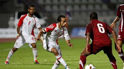 Ali Al Wehaibi, left, attempts to bypass Meshal Mubarak during the friendly between UAE and Qatar.