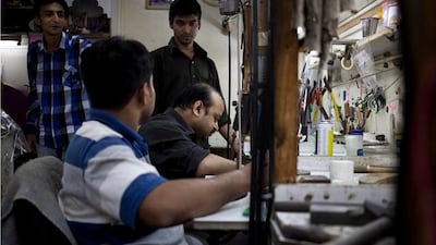 Goldsmiths work on items at the workshop of Nirali & Mickey Diamond and Jewellery at the Gold Souq in Deira.