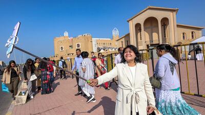 A woman uses a phone on a selfie stick to take a photo outside the Catholic Co-Cathedral of the Holy Family in Kuwait City on Christmas. AFP