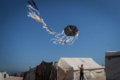 Iyad Tanbura, 10, flies a home-made kite in a tent camp in Gaza city on June 2. Anadolu via AFP