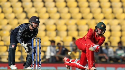 Sean Williams (R) of Zimbabwe plays a shot as Scotland's Matt Cross looks on during the World T20 cricket tournament match between Scotland and Zimbabwe at the Vidarbha Cricket Association Stadium in Nagpur on March 10, 2016. / AFP / PRASHANT BHOOT