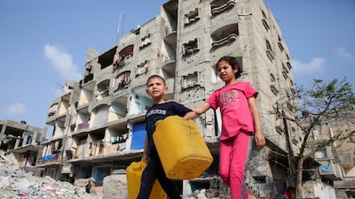 Palestinian children walk past a house damaged in an Israeli strike in Rafah in the southern Gaza Strip. Reuters
