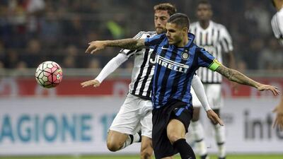 Juventus' Claudio Marchisio, left, challenges Inter Milan's Mauro Icardi during a Serie A soccer match between Inter Milan and Juventus at the San Siro stadium in Milan, Italy. (AP Photo/Luca Bruno)