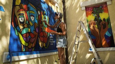 Senia Cade, curated by Paints Institute, paints a mural on the boarded-up windows of St. John's Church as a work of art activism for racial justice at Black Lives Matter Plaza in Washington, U.S. REUTERS