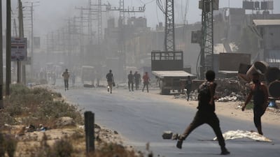 Palestinians flee following an Israeli strike in Maghazi, central Gaza Strip. AFP