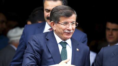 Turkey’s prime minister Ahmet Davutoglu greets worshippers as he leaves a mosque after Friday prayers in Ankara. Umit Bektas / Reuters