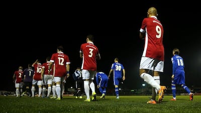 Salford City and Notts County players walk onto the pitch at Moor Lane on Friday night for their FA Cup contest. Chris Brunskill / Getty Images