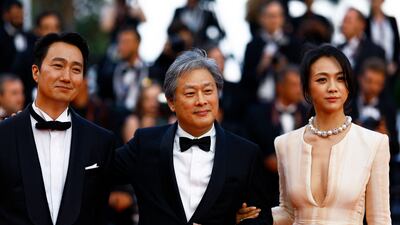 Director Park Chan-wook and cast members Tang Wei and Park Hae-il after the Cannes screening of Decision to Leave (Haeojil Gyeolsim). Reuters