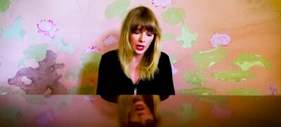 Taylor Swift perfromed in front of lotus flower-print wallpaper. YouTube