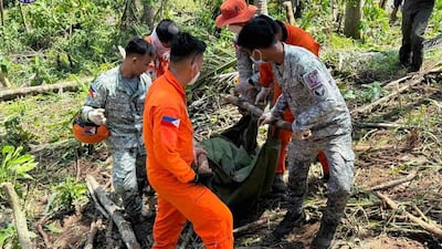 Philippine Air Force personnel retrieve the remains of the pilots and crew of the Super Huey helicopter a day after it crashed in Agusan del Sur province, southern Philippines while on a humanitarian and disaster response mission due to Typhoon Kalmaegi. AP