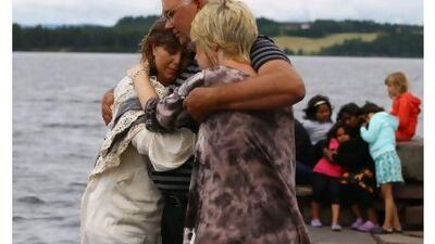 Relatives gather to observe a minute's silence opposite Utoya Island, after Friday's twin extremist attacks in Norway. Jeff J Mitchell / Getty Images