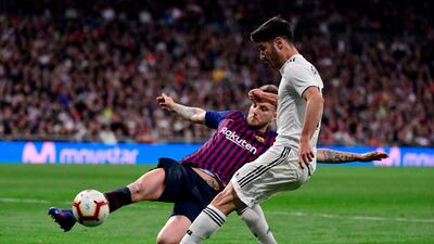 Real Madrid's Marco Asensio challenges Barcelona's Croatian midfielder Ivan Rakitic. AFP