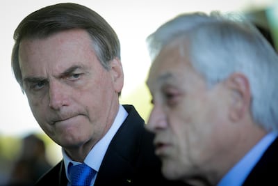 Jair Bolsonaro, Brazil's president, listens as Sebastian Pinera, Chile's president, speaks during a joint press conference at the Alvorada Palace in Brasilia, Brazil, on Wednesday, August 28, 2019. Andre Coelho/Bloomberg