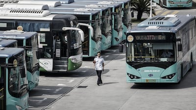 A worker walks while a BYD Co. electric bus arrives at a public transportation hub in Shenzhen, China, on Wednesday, Sept. 20, 2017. China, the world’s biggest auto market, may have all buses powered by batteries by 2020 and all other vehicles will follow suit by 2030, BYD Chairman Wang Chuanfu predicts. Photographer: Qilai Shen/Bloomberg