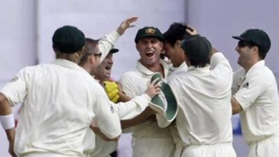 Australian players celebrate with Matthew Hayden, centre, after he took a catch to dismiss the Indian batsman Virender Sehwag.