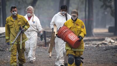 California Department of Forestry and Fire Protection workers carry excavating tools in Magalia, California. Bloomberg