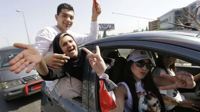 Syrian nationals living in Lebanon gesture as they arrive outside the Syrian Embassy in Yarze east of Beirut before voting in the upcoming presidential elections. Joseph Eid / AFP