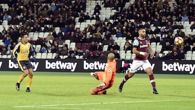 Arsenal's Alexis Sanchez, left, scores his third goal in a 5-1 win against West Ham United at Emirates Stadium in London, England, on Saturday, December 3, 2016. Hannah McKay / EPA