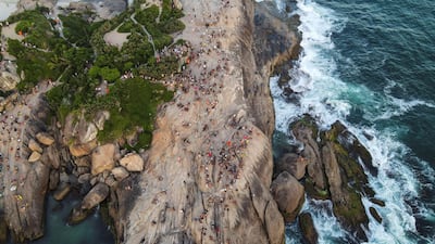 Dozens of people watch the sunset at Arpoador beach, near Ipanema, Rio de Janeiro, Brazil. EPA