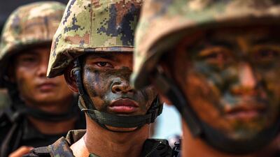 Thai marines line up on a beach after taking part in a drill in the coastal province of Chonburi. AFP