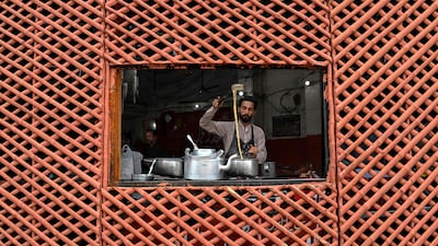A vendor prepares tea for customers at a roadside stall in Lahore, Pakistan. AFP