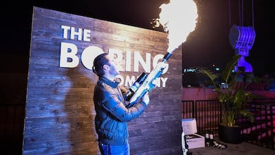 An attendee operates a Boring Company flamethrower during the unveiling event. EPA