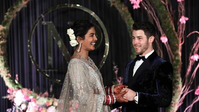 Newlyweds Priyanka Chopra, 36, and Nick Jonas, 26, pose for a photograph during a reception at a hotel in New Delhi on December 4, 2018. Photo: EPA