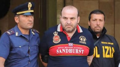 Italian Elio Amato (C) pictured during his arrest by Italian police on in Naples. Amato was on the country's list of 100 most dangerous wanted criminals.