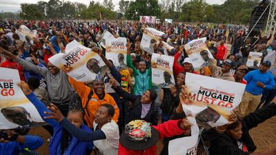 Protesters hold posters asking president Mugabe to step down, on which one has handwritten "37 years for nothing", at a demonstration at Zimbabwe Grounds in Harare. Ben Curtis / AP Photo