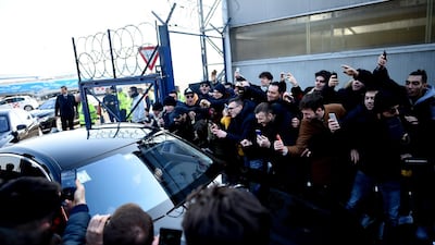 Ibrahimovic leaves in a car surrounded by supporters. AFP