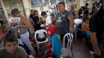 A young Israeli boxer waits for his fight during the Israel National Youth Boxing Championship at the Arab village of Kfar Yasif, northern Israel.