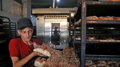 Traditional sweets being prepared at a bakery run by displaced Syrians in the town of Dana, east of the Turkish-Syrian border in the northwestern Idlib province. Aaref Watad / AFP