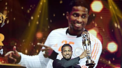Saudi Arabia Al Hilal striker Nassir Al Shamrani raises the trophy after winning the Asian Football Confederation (AFC) Player of the Year during the AFC's 60th Anniversary and Annual Awards held in Manila on November 30, 2014. NOEL CELIS / AFP