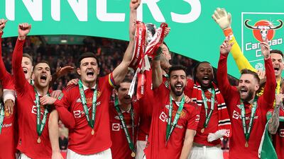 Harry Maguire and Bruno Fernandes of Manchester United lift the League Cup trophy. Getty